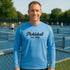Man wearing a blue 'Pickleball Est. 1965' shirt on a pickleball court.